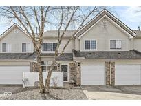 Charming townhouse featuring a one-car garage and well-maintained front yard at 5845 Shipwatch Pl, Indianapolis, IN 46237