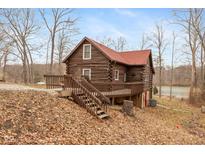 Charming log cabin with a spacious deck, nestled in a wooded setting with lake access at 7987 N Lasalle Rd, Morgantown, IN 46160