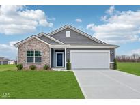 Charming single-story home featuring a brick and vinyl facade, well-manicured lawn, and an attached two-car garage at 113 Luna Pl, Shelbyville, IN 46176