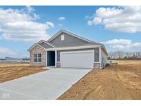 Beautiful single-Gathering home featuring brick and siding, a two-car garage, and a well-manicured lawn at 113 Luna Pl, Shelbyville, IN 46176