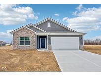 Charming single-Gathering home featuring brick and siding, a two-car garage, and a well-manicured lawn at 113 Luna Pl, Shelbyville, IN 46176