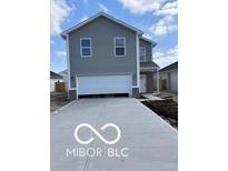 Charming two-story home with gray siding, a wide driveway, and a spacious two-car garage at 1433 Wigwam Ln, Martinsville, IN 46151