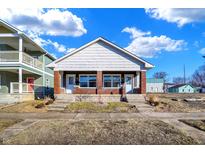 Charming bungalow featuring dual entrances, brick accents, and a classic gable roof design at 1622 Prospect St, Indianapolis, IN 46203