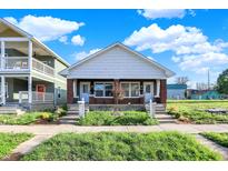 Charming bungalow-style home featuring dual entrances, a covered porch, and a manicured lawn at 1622 Prospect St, Indianapolis, IN 46203