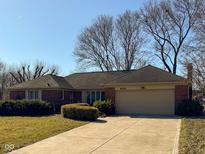 Charming red brick ranch home with attached garage and well-manicured landscaping at 628 Folcroft Ct, Indianapolis, IN 46234