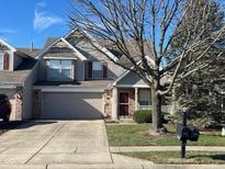 Charming two-story townhome with a well-maintained front yard and attached garage, offering curb appeal and convenience at 6442 E Flat Rock Dr, Camby, IN 46113