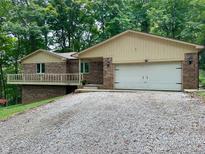 Charming brick home featuring an attached two-car garage and a partially covered front porch at 797 S Graveyard Rd, Paragon, IN 46166