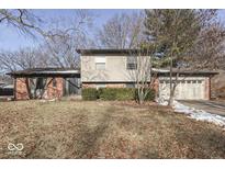 Brick ranch home with attached garage and landscaped yard at 3310 Acacia Dr, Indianapolis, IN 46214
