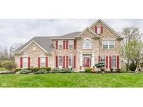 Charming brick two-story home with red shutters and well-manicured lawn, offering classic curb appeal at 10866 Flower Mound Pl, Fishers, IN 46037