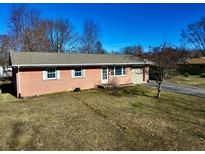 Charming single-story brick home with attached garage, front yard, and inviting entrance at 11962 Trolley Rd, Indianapolis, IN 46236