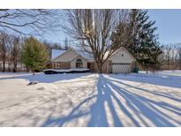 Brick ranch home with attached garage, nestled on a snowy lot at 6361 Crystal Springs Dr, Avon, IN 46123