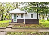 Charming single-story home with white siding, covered porch, and well-maintained front yard at 715 N Warman Ave, Indianapolis, IN 46222