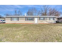 Ranch style home with brick exterior, landscaped lawn, and a spacious front yard at 8390 E Us 36 Hwy, Avon, IN 46123