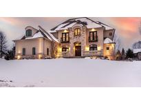 Two-story house with stone accents and a snowy front yard at 1023 Westview Point Dr, Columbus, IN 47201