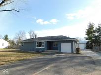 Gray house with white garage and landscaping at 1513 Laurel Dr, Columbus, IN 47203