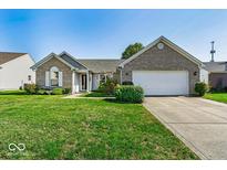 Brick ranch home with a two-car garage and well-maintained lawn at 5849 Jamestown Square Ln, Indianapolis, IN 46234
