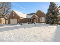 Brick ranch home with attached garage and snow covered yard at 6151 W Richman Ln, New Palestine, IN 46163