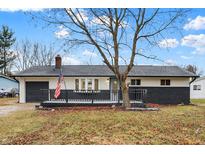 Newly renovated Ranch home featuring a gray and white exterior, modern deck, and landscaped yard at 11010 Broadway St, Carmel, IN 46280
