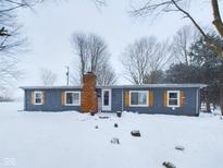 Ranch style home with gray siding and snowy yard at 2882 N Indiana 13, Anderson, IN 46011