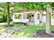 Brick home with front porch and landscaped lawn at 936 N Oxford St, Indianapolis, IN 46201
