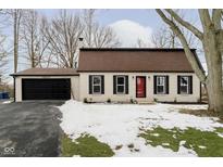 Charming ranch home with red and white exterior, black shutters, and attached garage at 10629 Maze Rd, Indianapolis, IN 46259