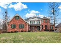 Brick two-story house with green shutters, a large front yard, and a wrap-around porch at 1398 Penny Ln, Greenfield, IN 46140