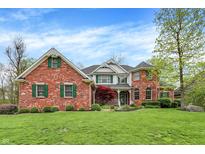 Inviting two-story brick home with manicured lawn, lush landscaping, and traditional architectural details at 1398 Penny Ln, Greenfield, IN 46140