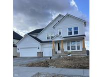 Charming two-story home with a three-car garage, light siding, and stylish wood-accented front porch columns at 20022 Boulder Brook Ln, Westfield, IN 46074