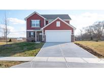 Two-story red brick and siding home with attached garage and landscaping at 4612 Amber Wood Dr, Indianapolis, IN 46235