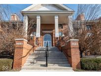 Brick building exterior with columns and grand staircase leading to the entrance at 8681 Jaffa Court East Dr # 16, Indianapolis, IN 46260