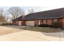 Brick duplex with attached garages and landscaped yards at 11 Eastern Ave, Brownsburg, IN 46112