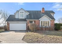 Brick house with gray siding, attached garage, and landscaping at 11725 Capistrano Dr, Indianapolis, IN 46236