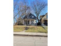 Charming two-story home with gray siding and a spacious front yard at 2955 N Olney St, Indianapolis, IN 46218