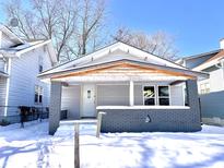 Newly painted craftsman home with covered porch and snow-covered yard at 330 Eastern Ave, Indianapolis, IN 46201