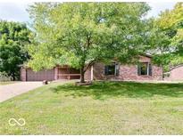 Brick ranch home with attached garage and spacious lawn at 3830 Pineview Ln, Greenwood, IN 46142