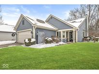 Gray house with a white garage door and well-manicured lawn at 8139 River Bay E Dr, Indianapolis, IN 46240