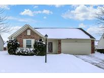 Brick ranch home with snow-covered lawn and attached garage at 10361 Cerulean Dr, Noblesville, IN 46060