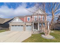 Two-story home with gray and red siding, large driveway and landscaping at 16172 Sedalia Dr, Fishers, IN 46040