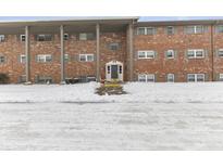 Brick building exterior with entrance and snowy landscaping at 5038 Allisonville Rd # A, Indianapolis, IN 46205