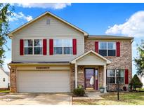 Two-story house with red shutters, brick accents, and a spacious driveway at 5340 Thompson Park Blvd, Indianapolis, IN 46237