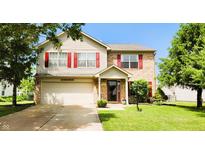Charming two-story home with a well-maintained lawn, attached garage, and inviting front porch at 5340 Thompson Park Blvd, Indianapolis, IN 46237