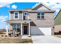 Charming two-story home featuring a well-manicured lawn, covered porch, and attached two-car garage at 5766 Aleppo Ln, Greenwood, IN 46143