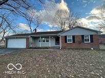 Brick ranch home with attached garage and landscaping at 6735 Dorchester Ct, Indianapolis, IN 46214