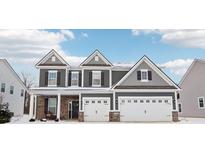 Two-story house with gray siding, brick accents, and a two-car garage at 6762 Hidden Meadow Pass, McCordsville, IN 46055