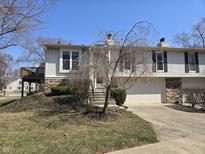 Charming home featuring a deck and well-maintained landscaping at 7629 Farm View W Cir, Indianapolis, IN 46256