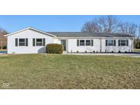 White ranch house with green shutters, landscaping, and a spacious lawn at 901 N 700 W, Greenfield, IN 46140