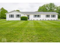 Charming one-story home with white siding, black shutters, and a lush green front lawn at 901 N 700 W, Greenfield, IN 46140