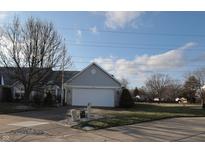 Gray siding ranch home with attached garage and manicured lawn at 11520 Coastal Way, Indianapolis, IN 46229