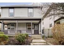 Two-story home with gray siding, front porch, and landscaping at 1421 E New York St, Indianapolis, IN 46201