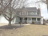 Charming two-story home with a welcoming front porch and attached two car garage at 18641 Wychwood Pl, Noblesville, IN 46062
